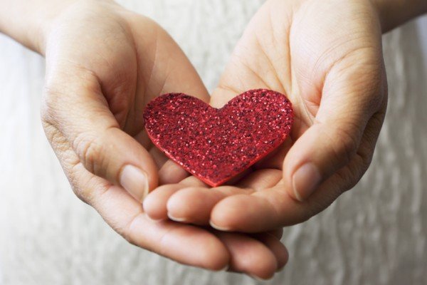 image of hands holding a sparkly red heart paper for our non profit it consulting services in NH